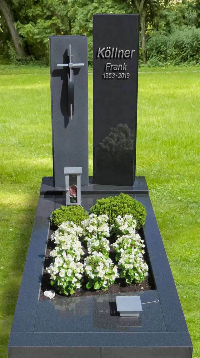 Tiefergelegtes Grab in schwarz und heller Bepflanzung